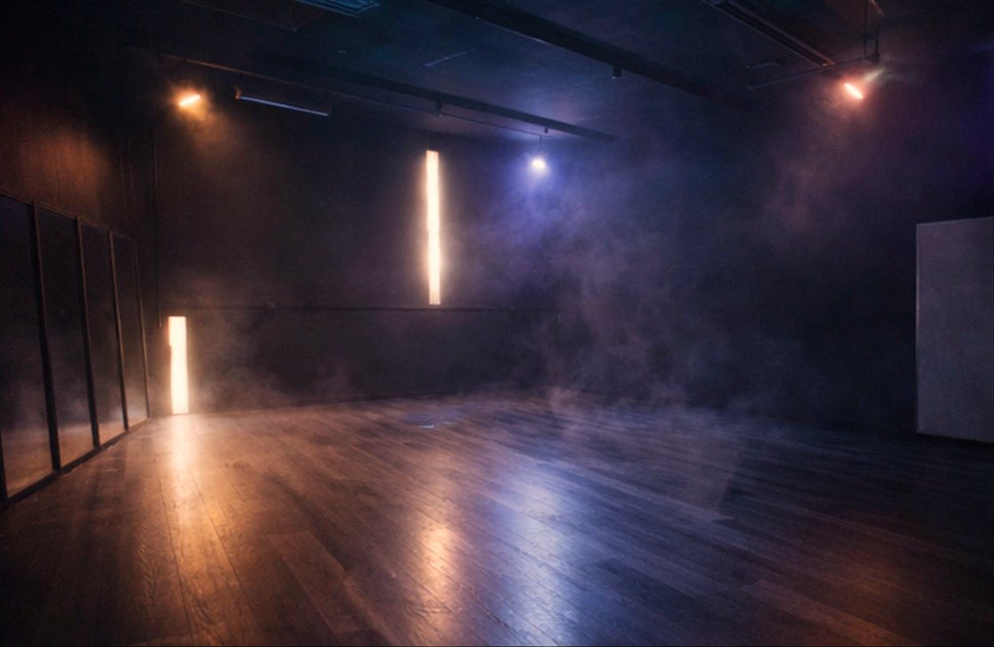 The YUX Studio black box lit with haze and light tubes